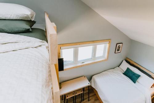 a bedroom with two beds and a window at Roamer's Nook in Nordegg