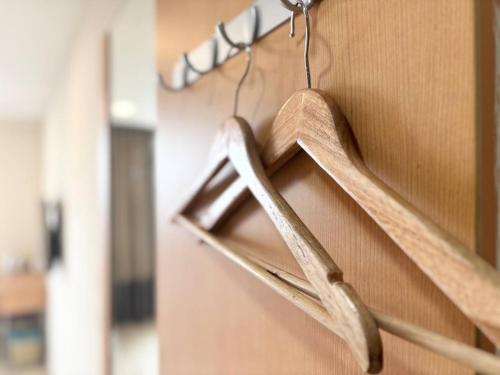 a wooden object is hanging on a wall at Signature Hotel by Easy Nap in Puchong