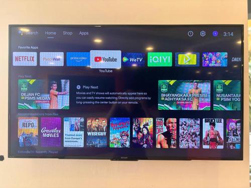 a television screen with a bunch of movies on it at Signature Hotel by Easy Nap in Puchong