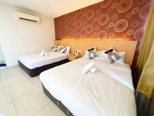 a hotel room with two beds with white sheets at Signature Hotel by Easy Nap in Puchong