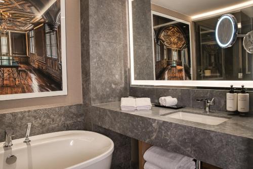 a bathroom with a tub and a toilet and a sink at InterContinental Hotels Real Lima Miraflores by IHG in Lima