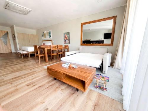 a bedroom with a bed and a table and a mirror at Spacious Apartment with Balcony in El Zonte