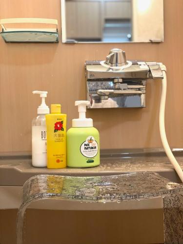 two bottles of cleaning products sitting on a table at Warm family stay ーEasy Access Kyoto & Osaka ー in Takatuki