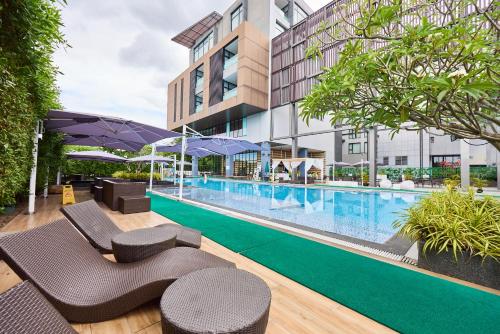 a hotel with a swimming pool and a building at Midori Clark Hotel and Casino in Clark