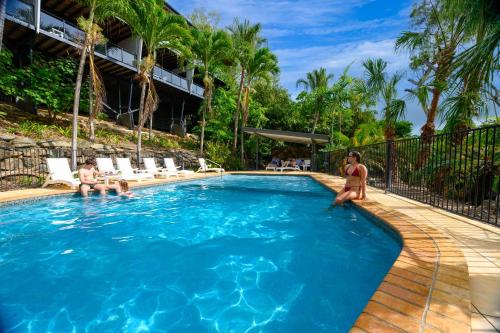 two people in a swimming pool at a resort at Shorelines in Hamilton Island