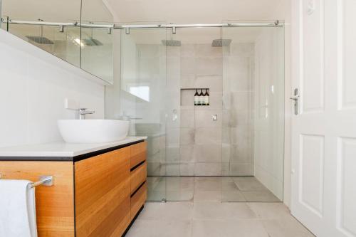a bathroom with a sink and a shower at Rivulet Retreat - Cosy South Hobart Home & Parking in West Hobart
