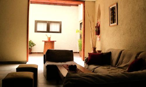 a living room with two couches and a table at Portal de La Cumbre in La Cumbre