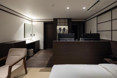 a hotel room with a bed and a reception desk at Aank Ryokan Hotel Suwon in Suwon