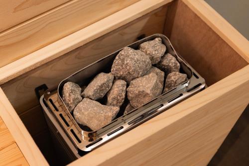 a drawer filled with rocks in a wooden cabinet at Aank Ryokan Hotel Suwon in Suwon