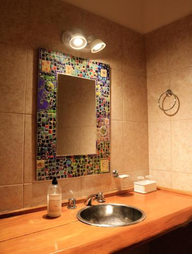 a bathroom with a sink and a mirror at Portal de La Cumbre in La Cumbre