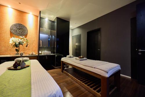 a bedroom with a bed and a bathroom with a mirror at Midori Clark Hotel and Casino in Clark