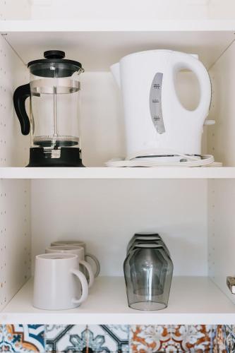 a shelf with a blender and other kitchen items at Trailhead Tuck-inn in Nordegg