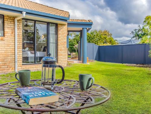 a table with a glass appliance on top of a yard at Ultimate Beachside Haven in Cabarita - Pet Friendly in Cabarita Beach