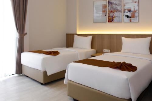 Ένα ή περισσότερα κρεβάτια σε δωμάτιο στο ICON City Hotel Samarinda
