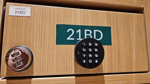 a wooden box with a black remote control in it at Apartemen 2BR Podomoro Lincoln Delipark Medan in Medan