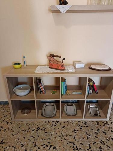 a wooden shelf with plates and a machine on it at PM 1 Via Ovidio Guest House in Leporano Marina