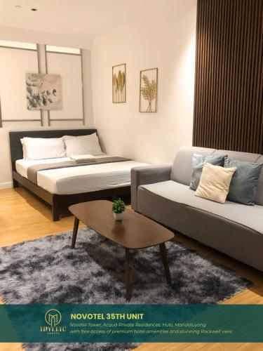 a living room with a bed and a couch at Novotel Tower at Mandaluyong Rockwell View in Manila