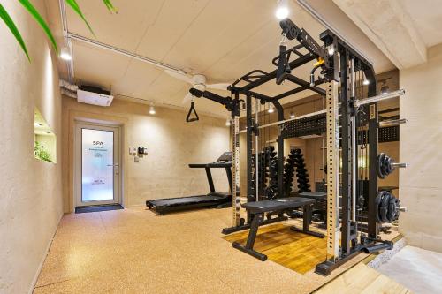 a gym with several tread machines in a room at Hta Tailored Service Home&fitness Near Seoul Stn in Seoul