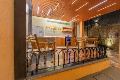 a balcony with chairs and a table in a restaurant at Casa Mayahuel in Oaxaca City