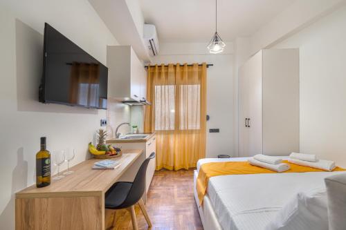 a room with two beds and a desk and a sink at Athens Meli in Athens