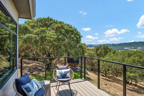 a balcony with two chairs and a view of trees at Luxury Modern Home with Views - 3 Acres, 4000 Sq Ft in Sonoma