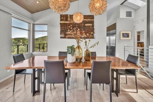 a dining room with a wooden table and chairs at Luxury Modern Home with Views - 3 Acres, 4000 Sq Ft in Sonoma