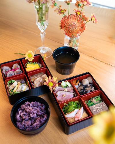 a table with three trays of different types of sushi at Hakuba Jolie Maison by Jade Group in Hakuba