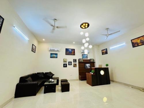 a living room with a couch and a table at Oxygen Inn-Couple Friendly-Noida Sector51 in Noida