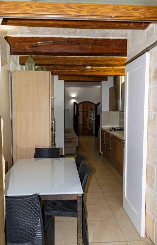 a kitchen and dining room with a table and chairs at Casa Naxxar 4 Floor Townhouse and Private Pool in Naxxar