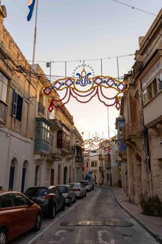 an alley with cars parked on the side of a street at Casa Naxxar 4 Floor Townhouse and Private Pool in Naxxar