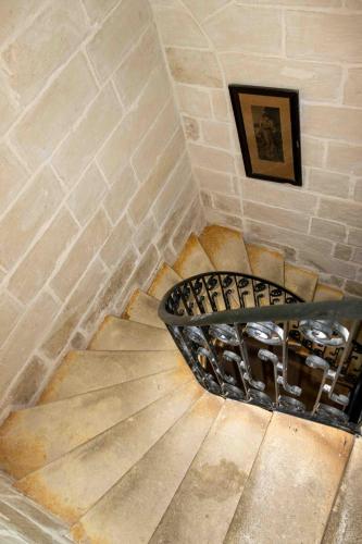 a spiral staircase in a room with a brick wall at Casa Naxxar 4 Floor Townhouse and Private Pool in Naxxar