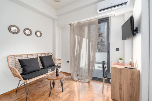 a living room with a couch and a table at Athens Meli in Athens