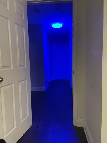 a blue room with a door and a blue light at Largest ensuite bedroom in a guest house in Whitby