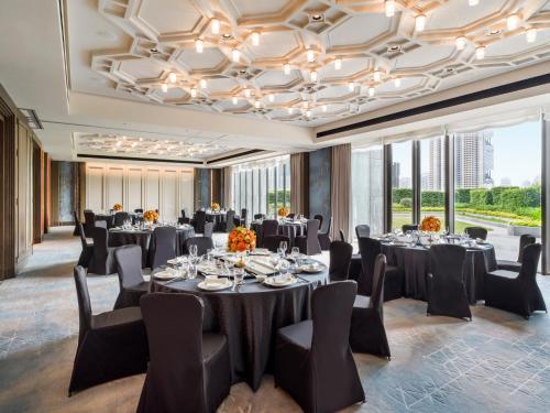 a conference room with tables and chairs and windows at The St. Regis Shenzhen Bao'an in Shenzhen