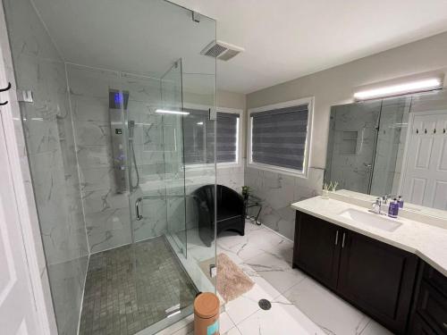 a bathroom with a glass shower and a sink at Largest ensuite bedroom in a guest house in Whitby