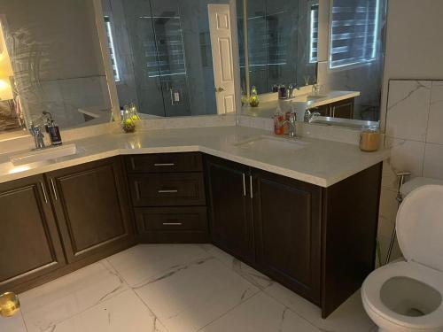 a bathroom with two sinks and a toilet at Largest ensuite bedroom in a guest house in Whitby
