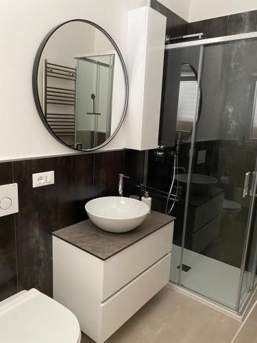a bathroom with a sink and a mirror at L’Incanto in Corsano