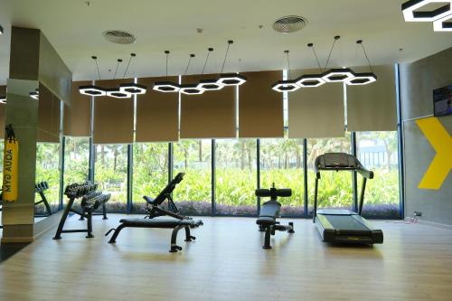 a gym with treadmills and exercise equipment in a room at Modern Beach Apartment - Arena Resort Cam Ranh in Cam Ranh International Airport