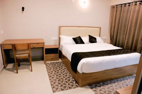 a bedroom with a bed and a nightstand and a bed sidx sidx sidx sidx at Lavender Airport Suite in Nedumbassery