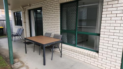 a table and chairs on a patio next to a building at The Goose Ponds in North Mackay