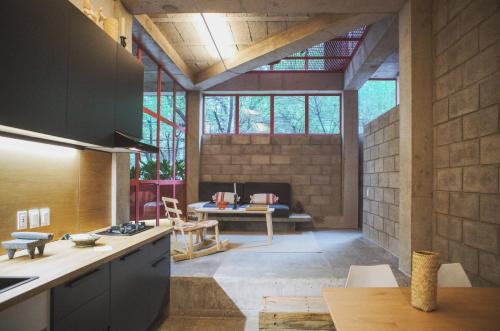 a kitchen and living room with a couch in the background at Xolo Condesa in Mexico City
