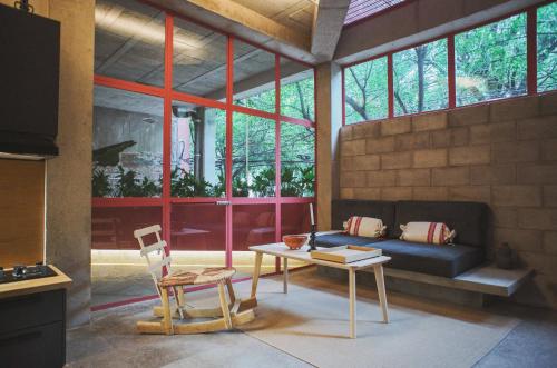 a living room with a couch and a table at Xolo Condesa in Mexico City