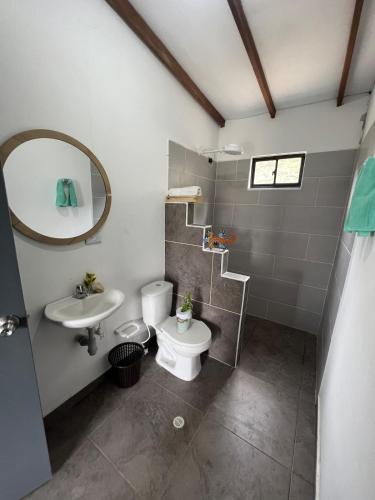 a bathroom with a toilet and a sink at Villa Amore in El Peñol