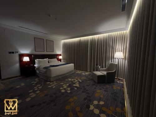 a hotel room with a bed and a chair at Alwadaq Hotel in Taif