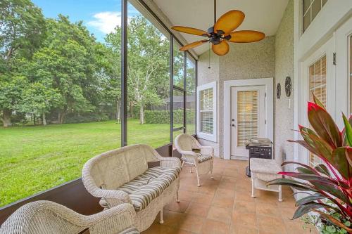 a porch with a couch and chairs and a fan at Beyond the Gate in Bay Tree in Pine Bluff