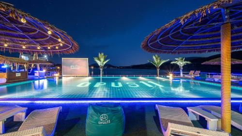 a swimming pool at night with chairs and umbrellas at Opus11 Poolvilla in Gyeongju