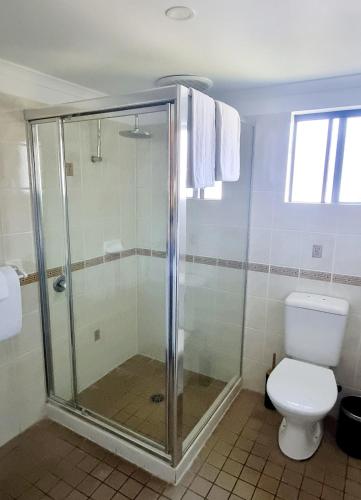a bathroom with a shower and a toilet at Hotel Forster in Forster
