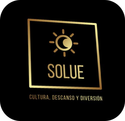a gold logo with a yellow sun on a black background at Solue in Duitama