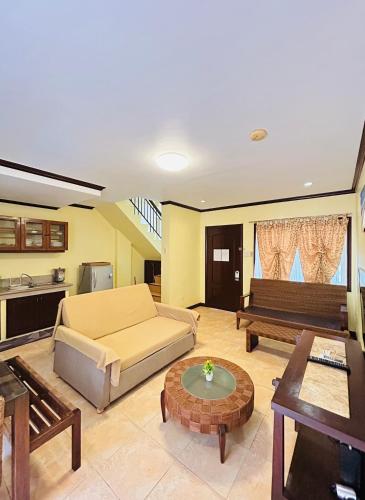 a living room with a couch and a table at Sheridan Villas Boracay in Boracay