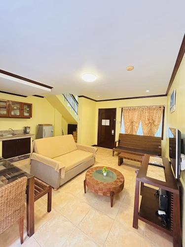 a living room with a couch and a table at Sheridan Villas Boracay in Boracay